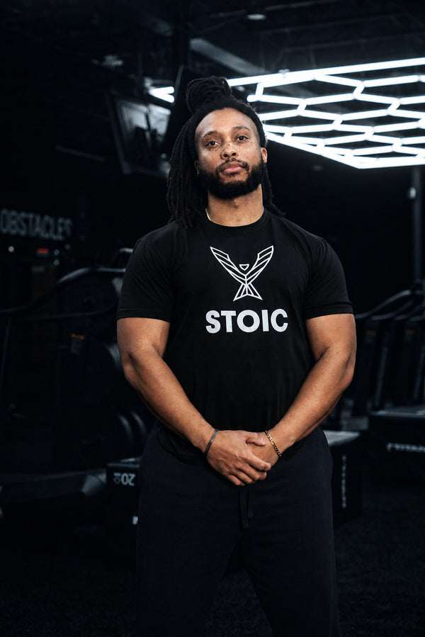 Man wearing the Stoic Performance black logo t-shirt in the gym
