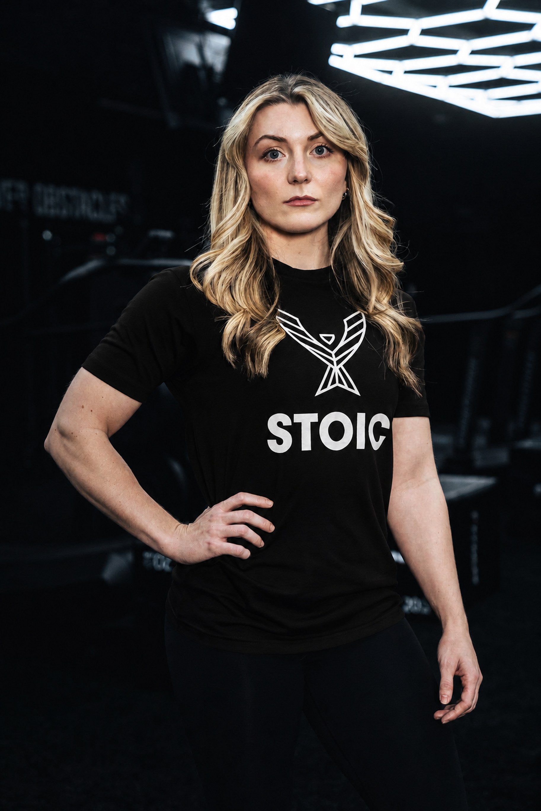 Woman wearing the Stoic Performance black logo t-shirt in the gym