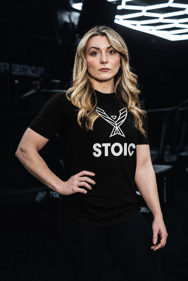 Woman wearing the Stoic Performance black logo t-shirt in the gym