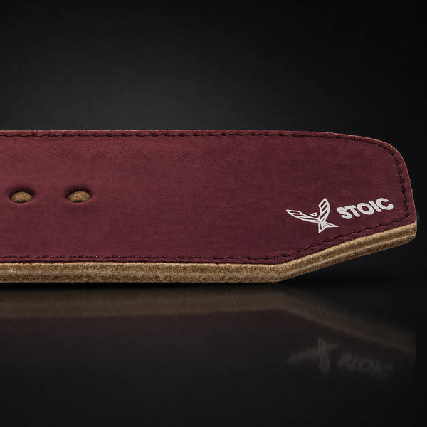 Stoic 10mm single-prong weight lifting belt in maroon, a close view of the tail, its adjustment holes and the angled chamfered tip.