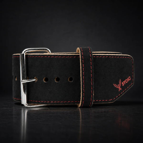 Stoic 10mm single prong weight lifting belt in red and black, on a dark studio background