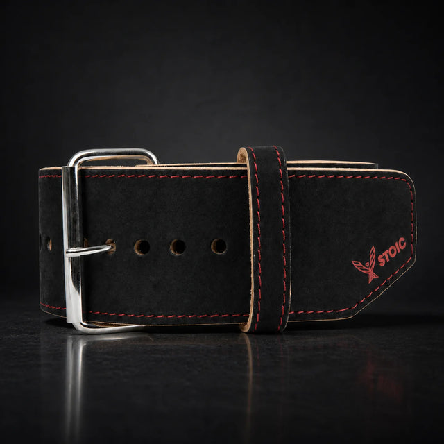 Stoic 10mm single prong weight lifting belt in red and black, on a dark studio background