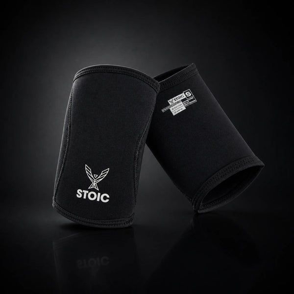 Stoic 7mm elbow sleeves for weightlifting, on a dark studio background