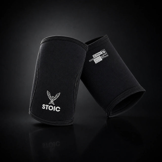 Stoic 7mm elbow sleeves for weightlifting, on a dark studio background