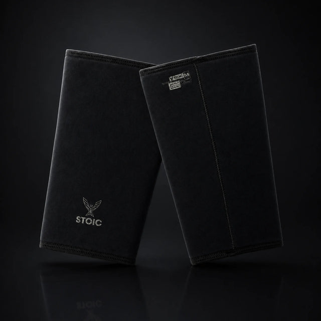 Stoic 7mm knee sleeves for weightlifting in Black Label, on a dark studio background