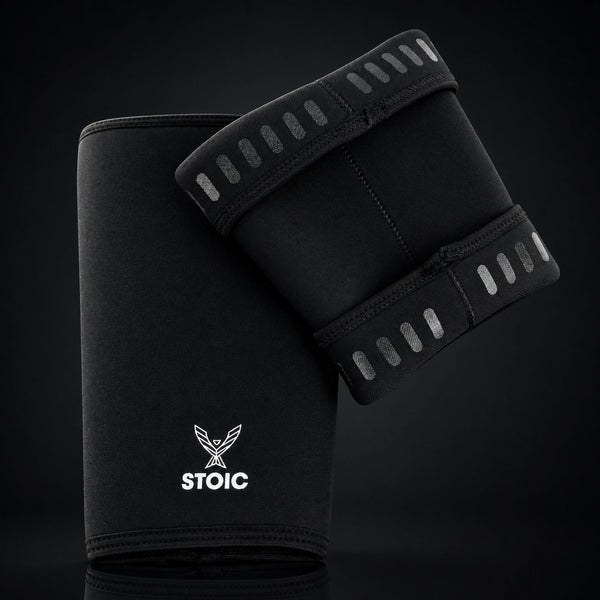 Stoic 7mm knee sleeves for weightlifting in black, the pair arranged with one sleeve showing the phoenix logo on its front and the other turned to reveal the silicone grip dashes inside the cuffs.