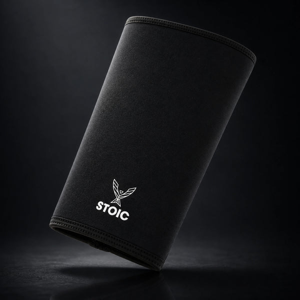 Stoic 7mm knee sleeves for weightlifting in black, a single sleeve leaning at an angle, front face with the phoenix logo.