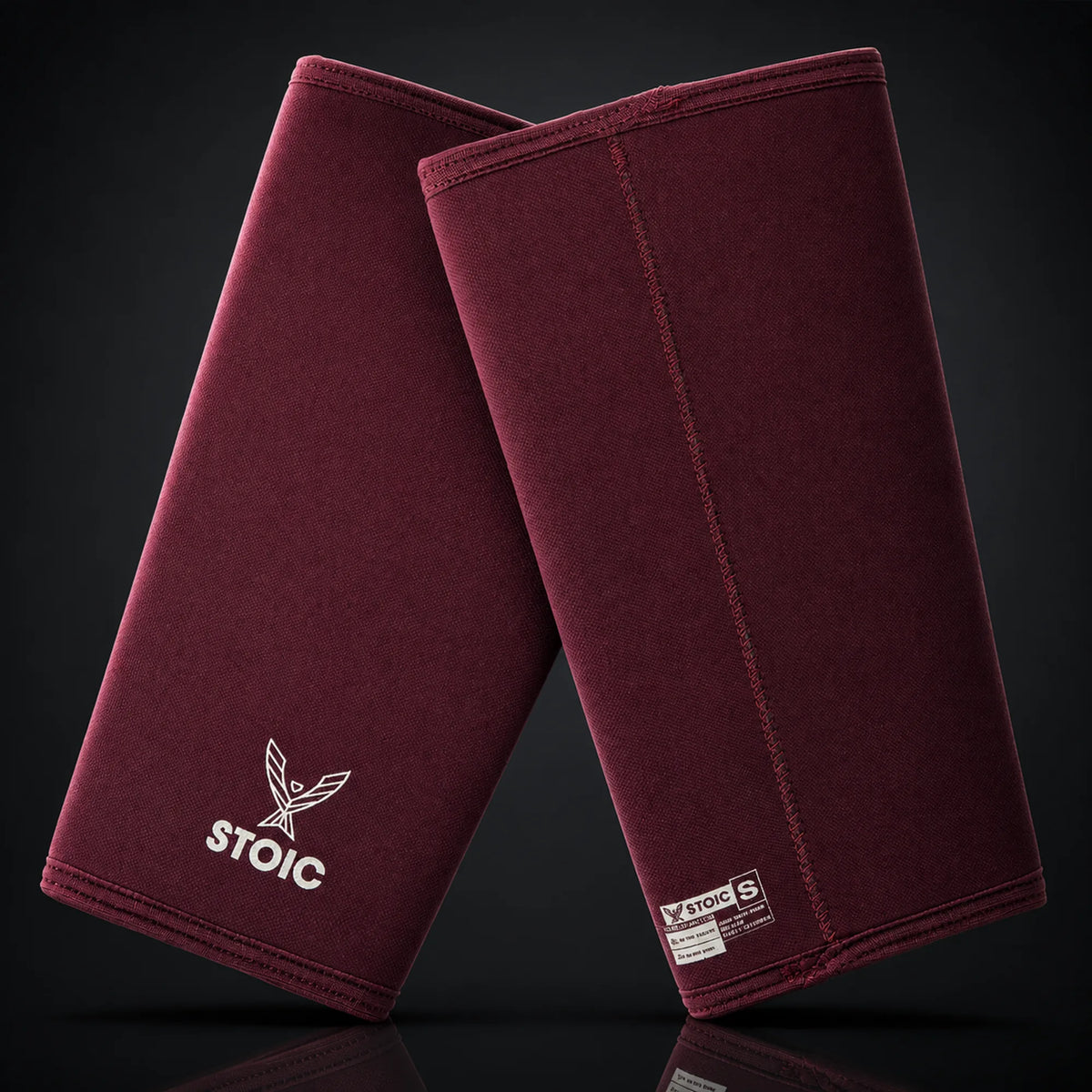 Stoic 7mm knee sleeves for weightlifting in maroon, on a dark studio background