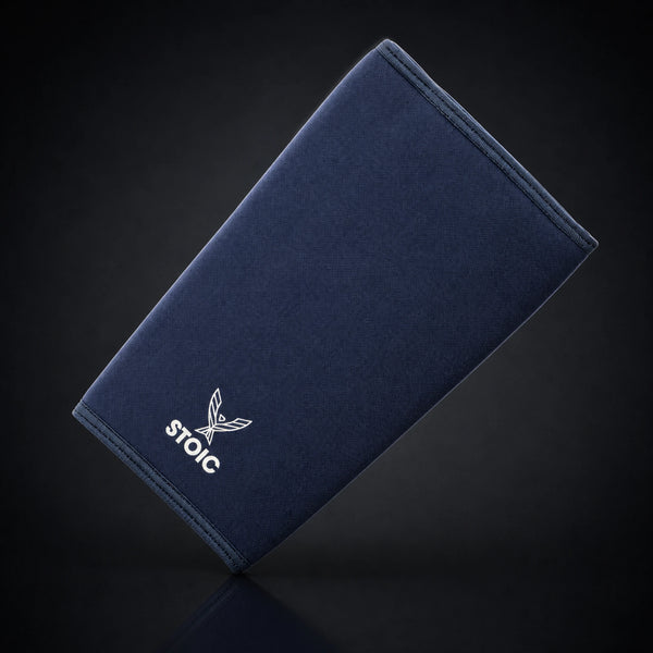 Stoic 7mm knee sleeves for weightlifting in navy, a single sleeve leaning at an angle, front face with the phoenix logo.