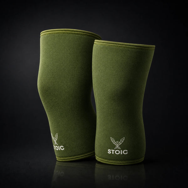 Stoic 7mm knee sleeves for weightlifting in olive drab, the pair standing upright, showing the contoured anatomical shape.