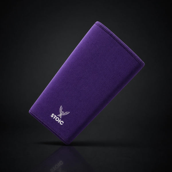 Stoic 7mm knee sleeves for weightlifting in purple, a single sleeve leaning at an angle, front face with the phoenix logo.