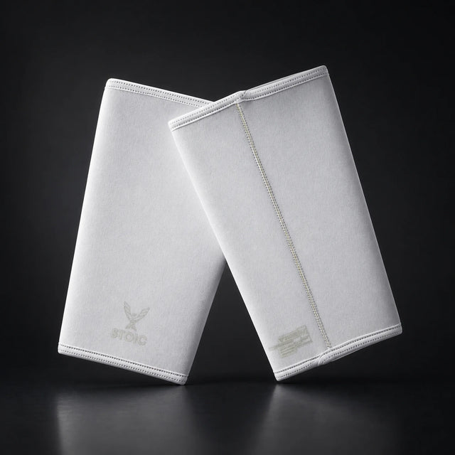 Stoic 7mm knee sleeves for weightlifting in white, on a dark studio background