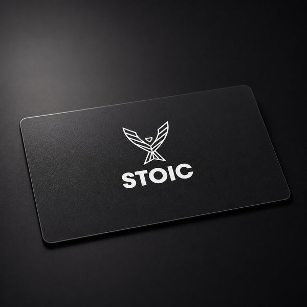 Stoic Performance gift card, a matte black card with the white Stoic phoenix logo, on a dark low-key studio background