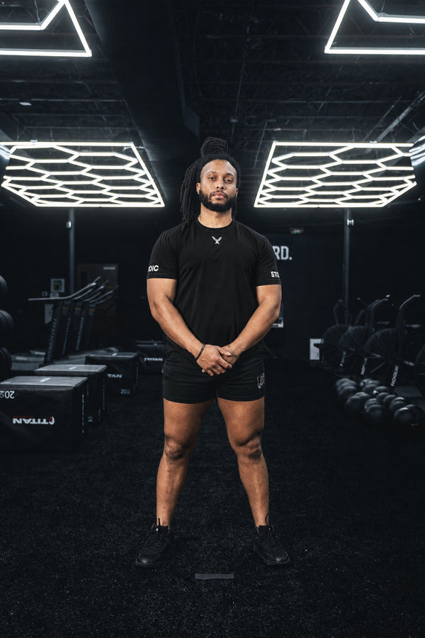 Full body view of the black Stoic Competition T-Shirt in the gym