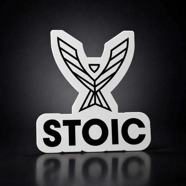 Stoic die-cut vinyl sticker, 2.75 inch, white vinyl with the black phoenix and STOIC logo, on a dark studio background