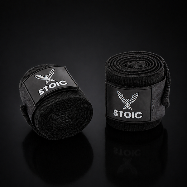 Stoic stiff support wrist wraps in black, coiled front view, on a dark studio background