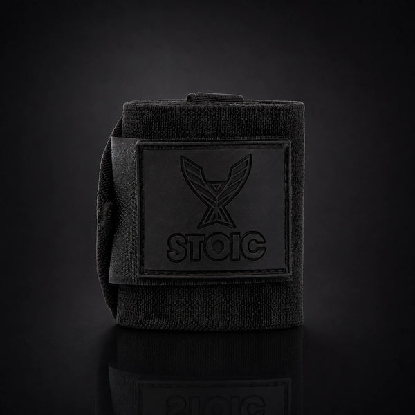 Stoic wrist wraps for weightlifting in Black Label, a single rolled wrap standing, logo patch facing the camera.