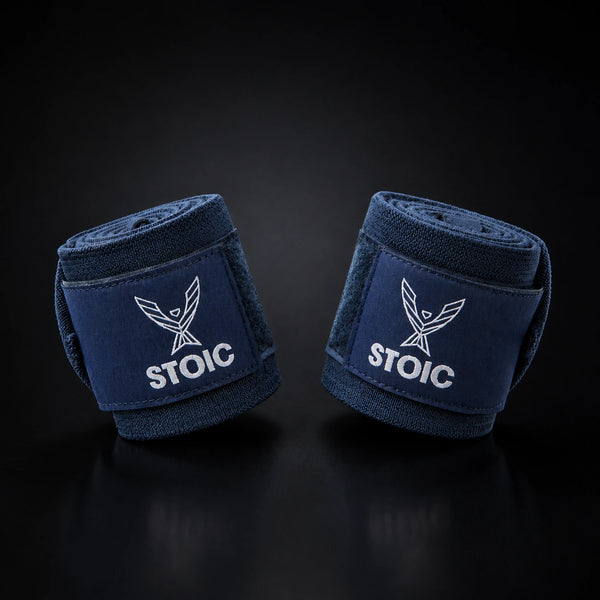 Stoic wrist wraps for weightlifting in navy, two rolled wraps tilted toward each other, logo patches facing the camera.