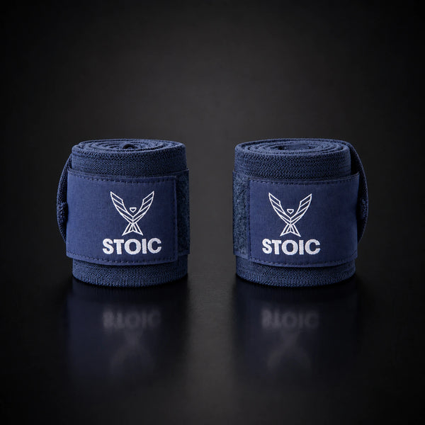 Stoic wrist wraps for weightlifting in navy, two rolled wraps standing apart, both logo patches facing the camera.
