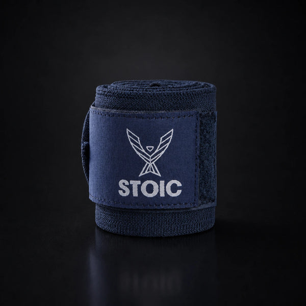 Stoic wrist wraps for weightlifting in navy, a single rolled wrap standing, logo patch facing the camera.