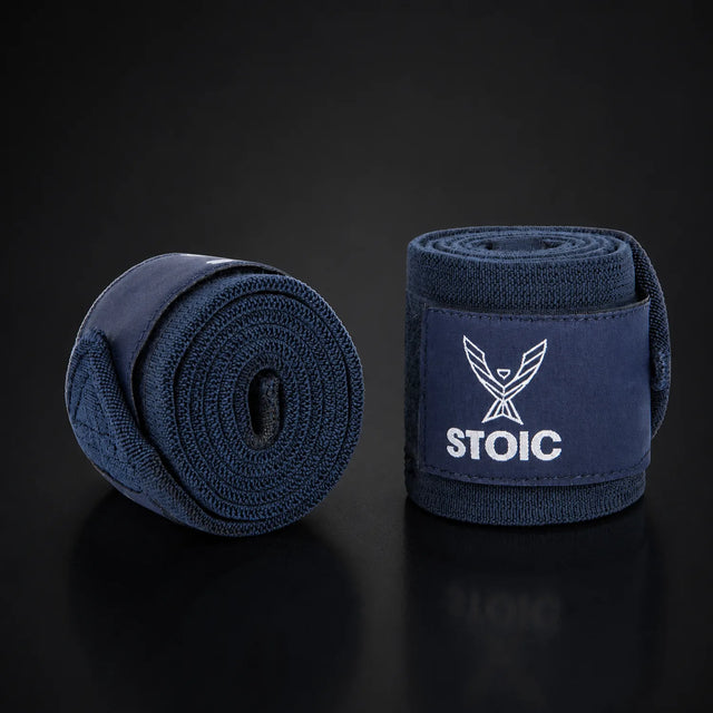 Stoic wrist wraps for weightlifting in navy, on a dark studio background