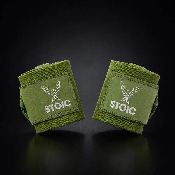 Stoic wrist wraps for weightlifting in olive drab, two rolled wraps tilted toward each other, logo patches facing the camera.