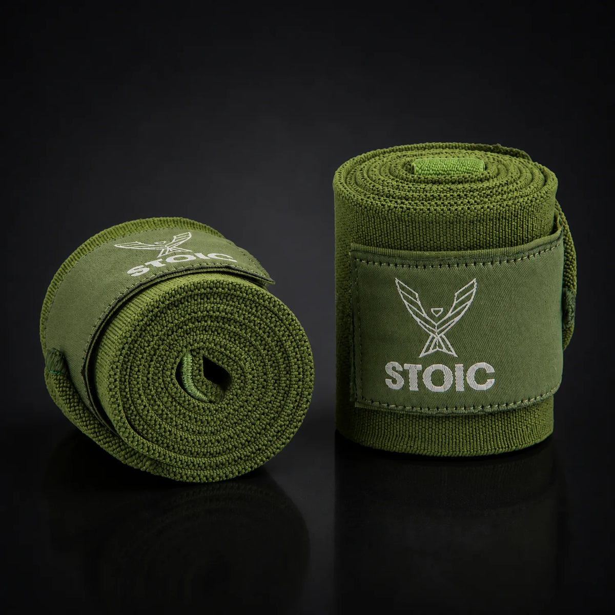 Stoic wrist wraps for weightlifting in olive drab, on a dark studio background