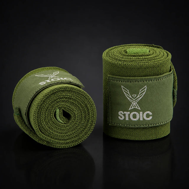 Stoic wrist wraps for weightlifting in olive drab, on a dark studio background