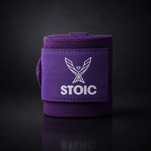Stoic wrist wraps for weightlifting in purple, a single rolled wrap standing, logo patch facing the camera.