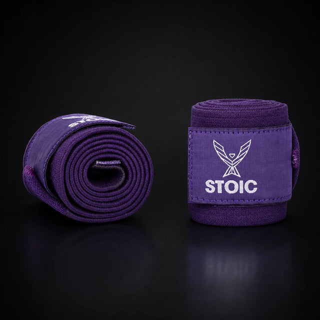 Stoic wrist wraps for weightlifting in purple, on a dark studio background