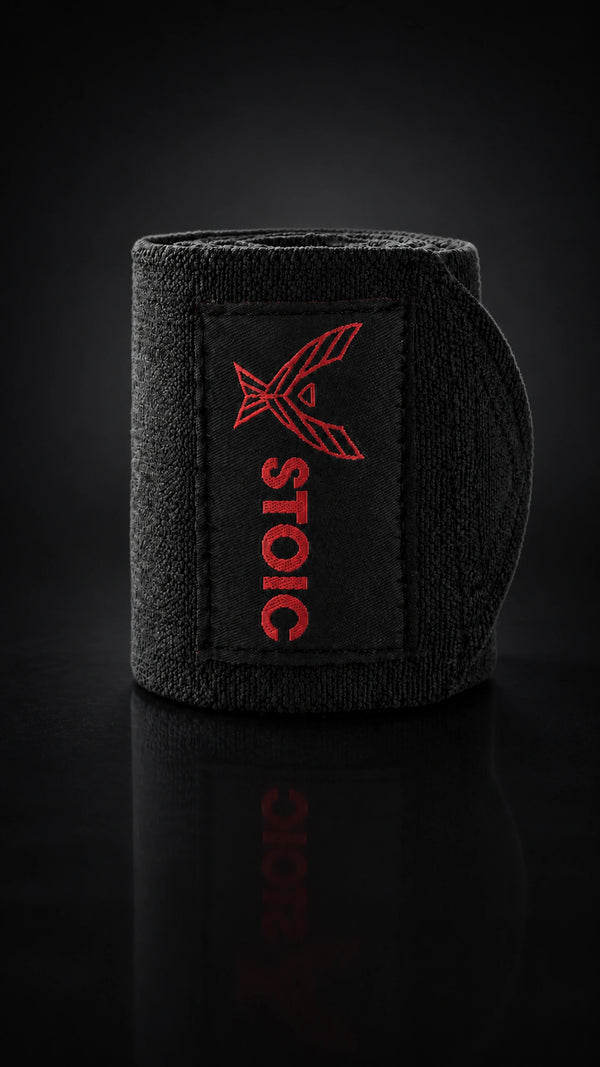 Stoic wrist wraps for weightlifting in Bloodline red and black, a single rolled wrap seen from the side.