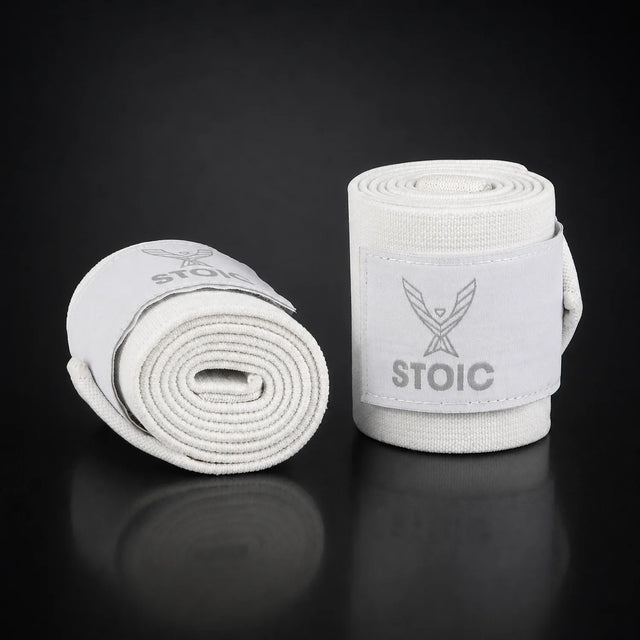 Stoic wrist wraps for weightlifting in white, on a dark studio background